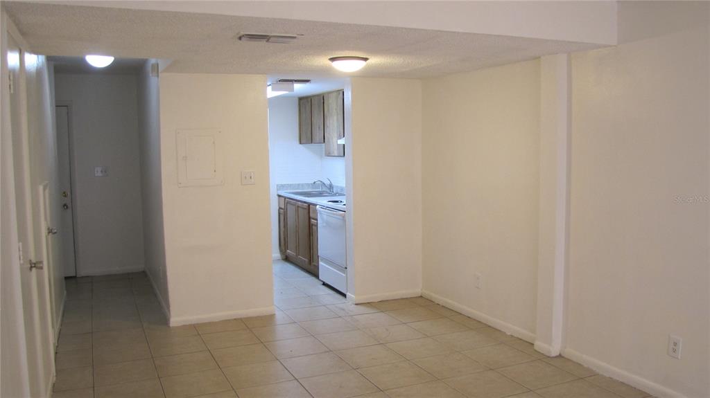5116 East Temple Heights Road, Unit A Tampa, FL 33617 - Photo 5 of 14 a view of a hallway with wooden floor