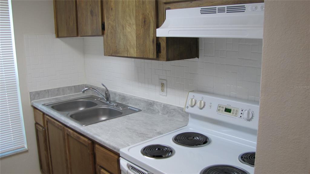 5116 East Temple Heights Road, Unit A Tampa, FL 33617 - Photo 6 of 14 a kitchen with a stove and a microwave