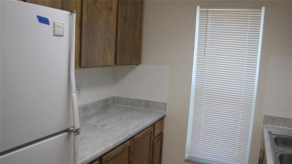 5116 East Temple Heights Road, Unit A Tampa, FL 33617 - Photo 8 of 14 a kitchen with a granite countertop window