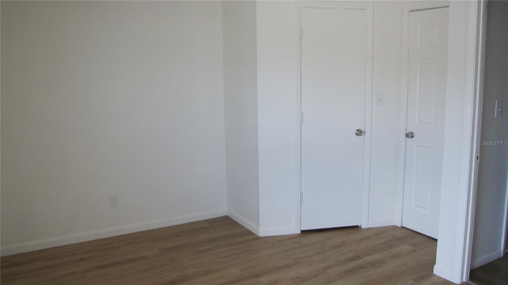 5116 East Temple Heights Road, Unit A Tampa, FL 33617 - Photo 10 of 14 a view of an empty room with wooden floor