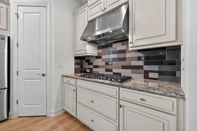 a kitchen with granite countertop a sink and a window