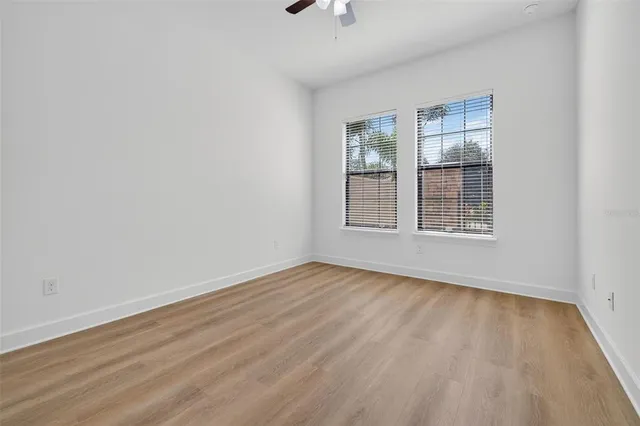 a kitchen with stainless steel appliances granite countertop a sink a stove and a wooden floors
