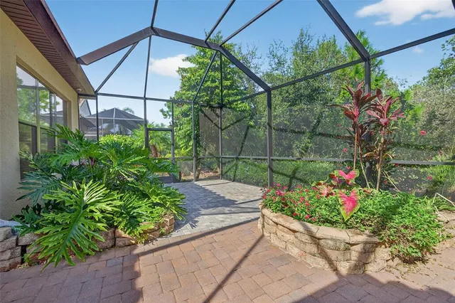 a front view of a house with a garden and trees