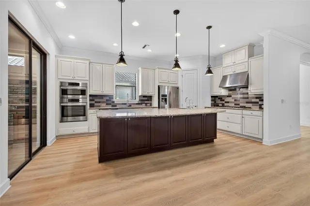 a kitchen with stainless steel appliances granite countertop a stove and a microwave