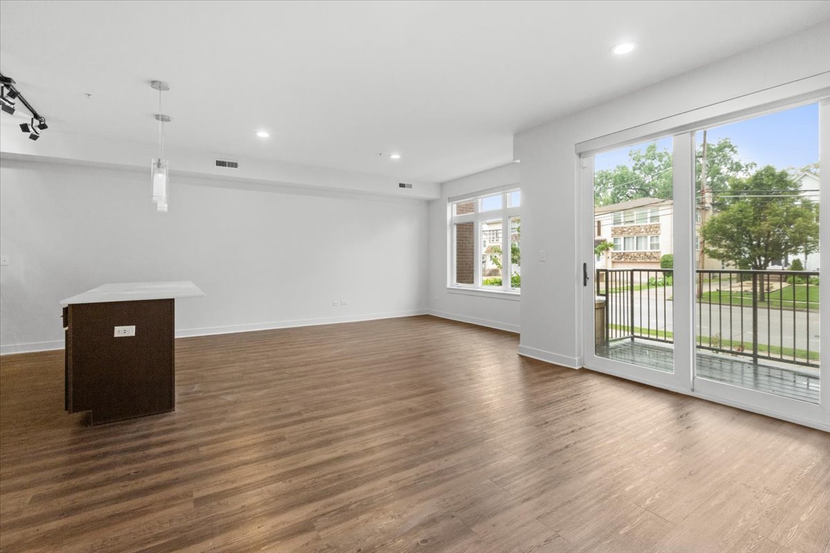 500 North Northwest Highway, Unit 113 Park Ridge, IL 60068 - Photo 4 of 12 an empty room with wooden floor and windows