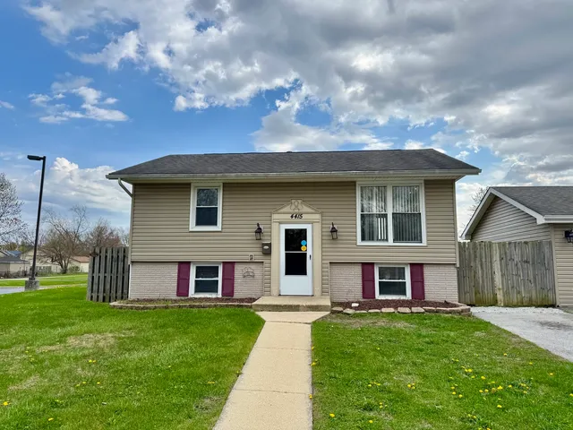 a view of house with a yard