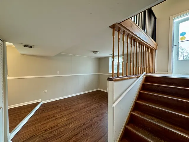 a view of an entryway with wooden floor