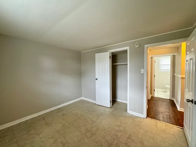 a view of an empty room and closet area