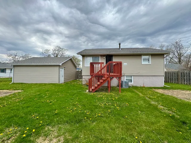 a backyard of a house with table and chairs