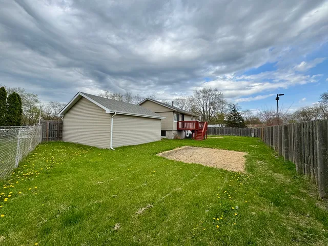 a view of a house with backyard and entertaining space