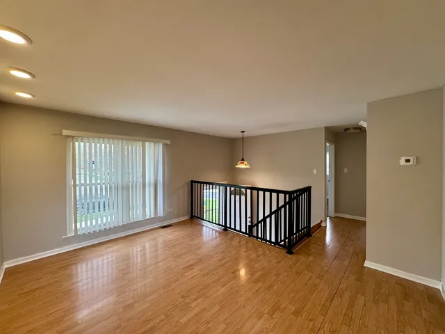 a view of an empty room with glass door