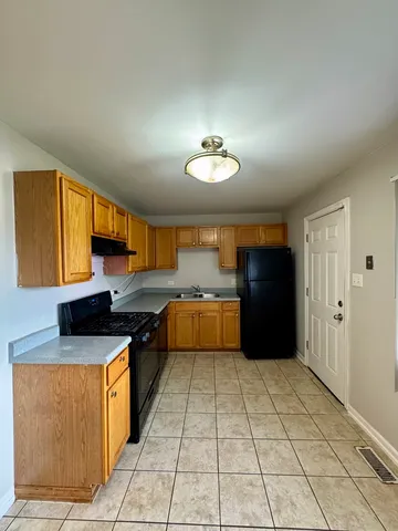 a kitchen with stainless steel appliances granite countertop a sink and cabinets