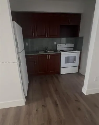 a view of a kitchen with appliances and cabinets