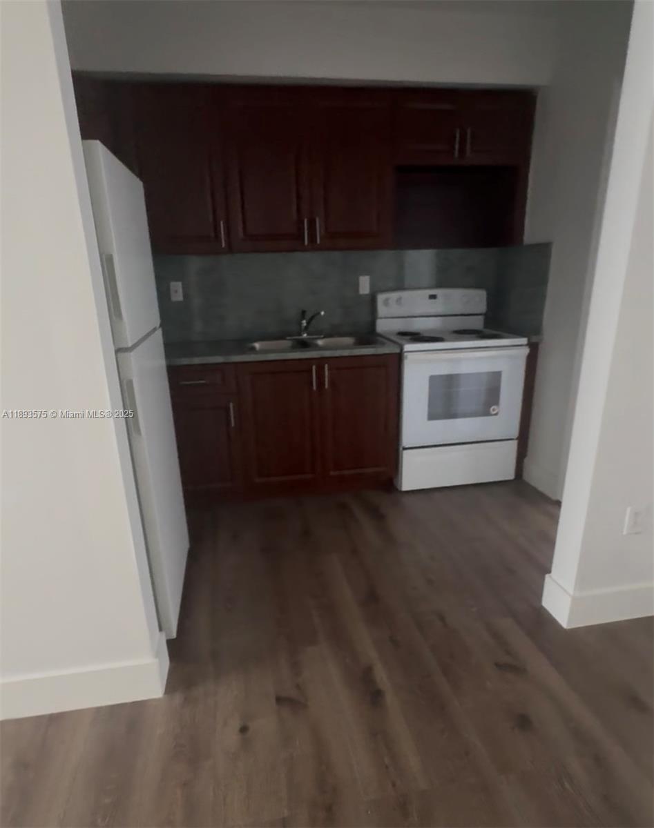 a view of a kitchen with appliances and cabinets