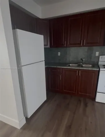 a white refrigerator freezer sitting inside of a kitchen