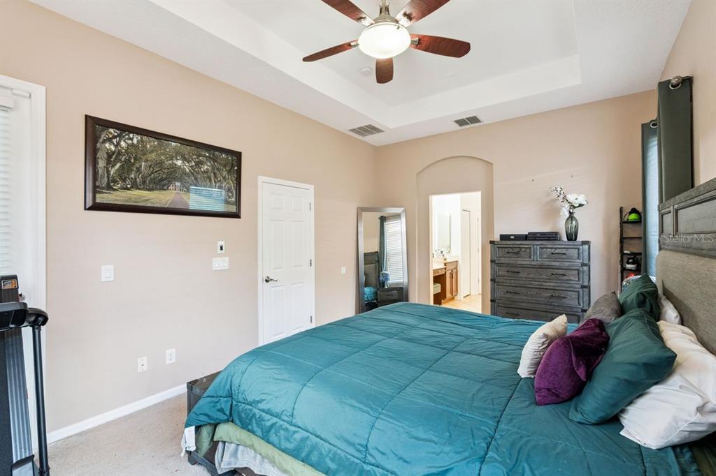 8484 Dover View Lane Orlando, FL 32829 - Photo 12 of 41 a bedroom with a bed and a chandelier
