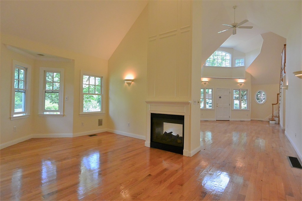 2 Prince Street Beverly, MA 01915 - Photo 2 of 30 an empty room with wooden floor fireplace and windows