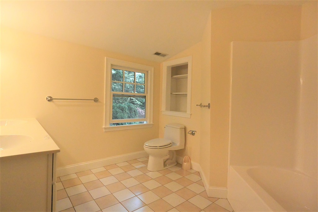 2 Prince Street Beverly, MA 01915 - Photo 24 of 30 a bathroom with a toilet a sink and a window