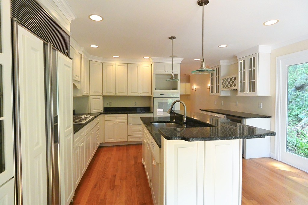 2 Prince Street Beverly, MA 01915 - Photo 3 of 30 a kitchen with kitchen island a large counter top a sink a refrigerator and a window