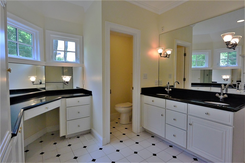 2 Prince Street Beverly, MA 01915 - Photo 4 of 30 a bathroom with a sink a toilet and mirror