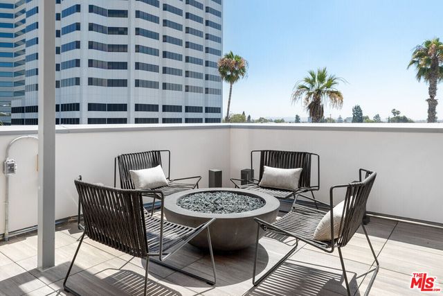 a view of a balcony with table and chairs