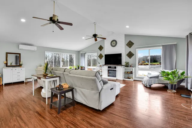 a living room with furniture and view of kitchen