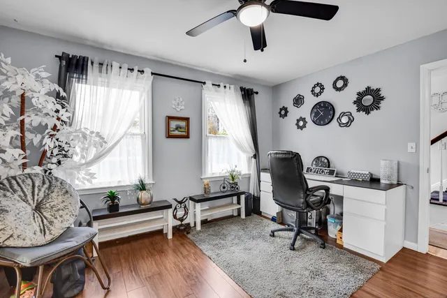 a view of a livingroom with workspace and a window