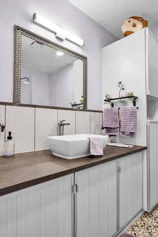 a bathroom with a sink and a mirror