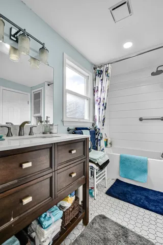 a bathroom with a sink a vanity and a mirror