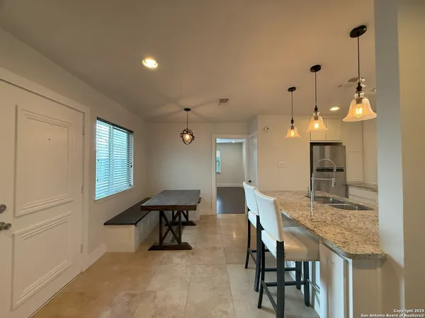 a dining room with furniture and window