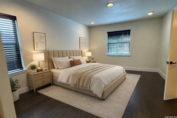 a spacious bedroom with a bed and window