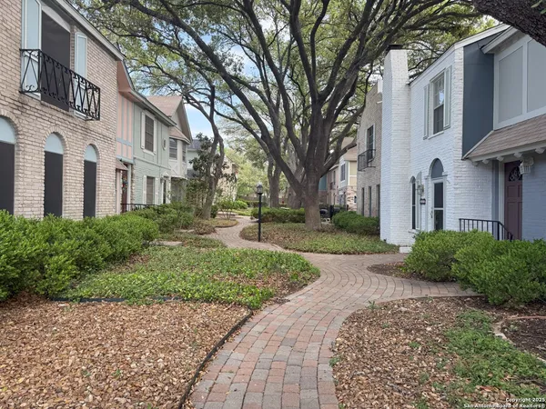 a view of a patio with table and chairs with wooden floor and fence