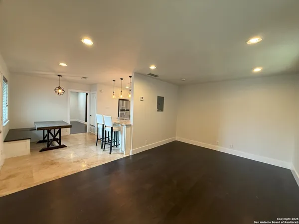 an empty room with furniture and a table