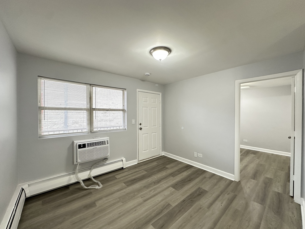 4616 North Beacon Street, Unit 2F Chicago, IL 60640 - Photo 14 of 21 wooden floor and windows in a room