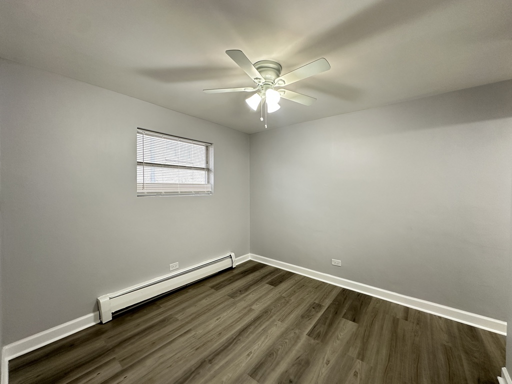 4616 North Beacon Street, Unit 2F Chicago, IL 60640 - Photo 17 of 21 wooden floor in an empty room