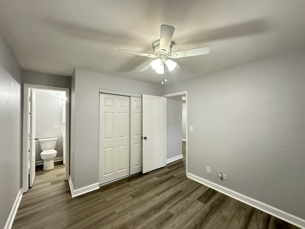 4616 North Beacon Street, Unit 2F Chicago, IL 60640 - Photo 19 of 21 an empty room with wooden floor fan and windows