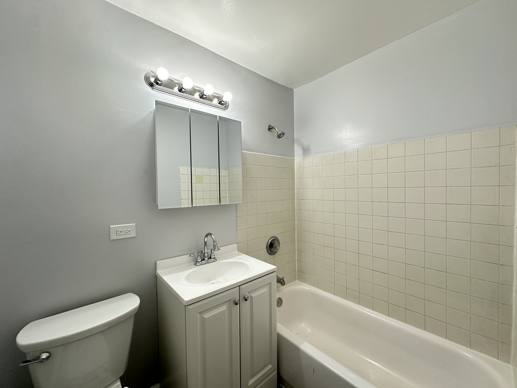4616 North Beacon Street, Unit 2F Chicago, IL 60640 - Photo 20 of 21 a bathroom with a sink toilet and shower