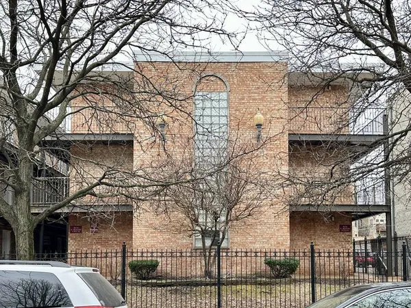 front view of a house with a large tree