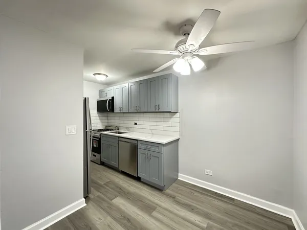 a kitchen with a stove and a refrigerator