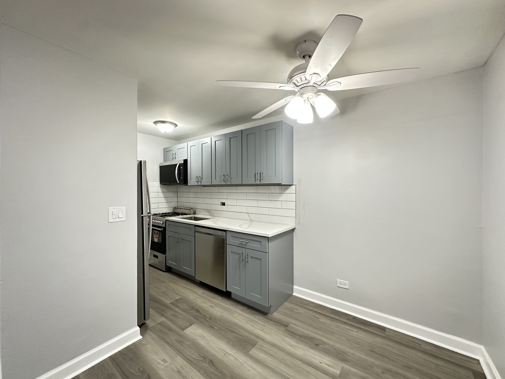 4616 North Beacon Street, Unit 2F Chicago, IL 60640 - Photo 5 of 21 a kitchen with a stove and a refrigerator