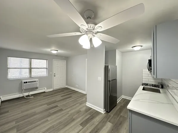 a view of a kitchen with a sink and a refrigerator