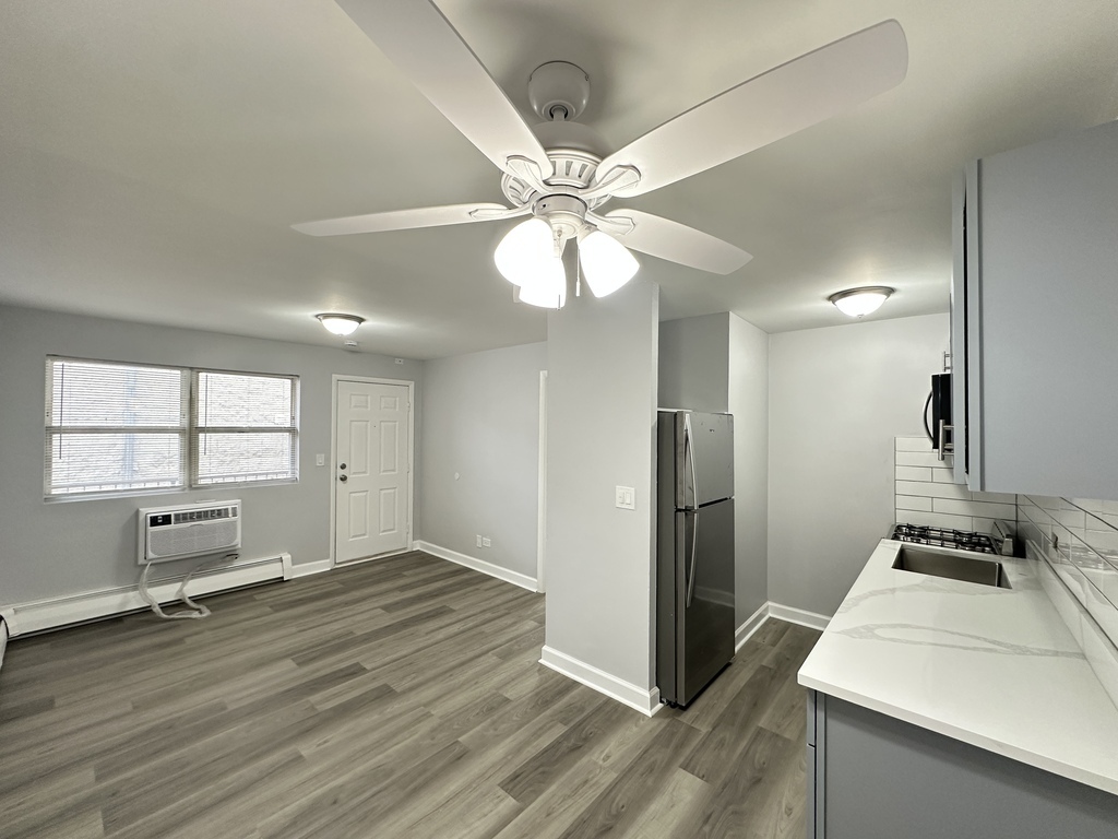 4616 North Beacon Street, Unit 2F Chicago, IL 60640 - Photo 7 of 21 a view of a kitchen with a sink and a refrigerator