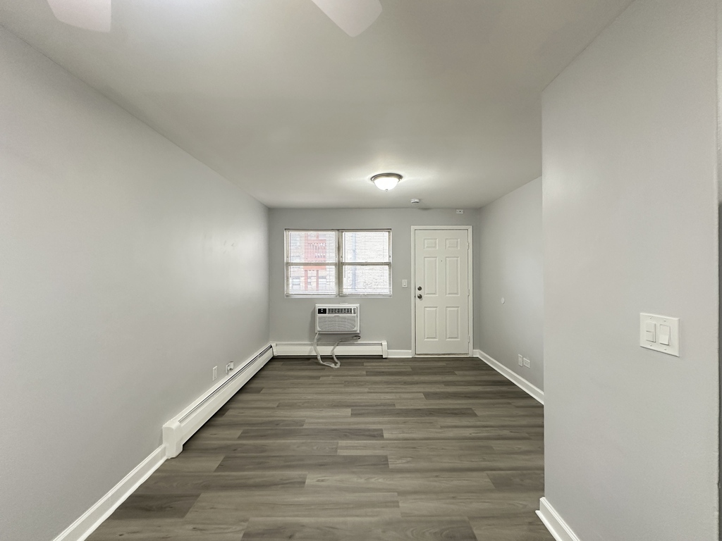 4616 North Beacon Street, Unit 2F Chicago, IL 60640 - Photo 8 of 21 a view of empty room with wooden floor and fan