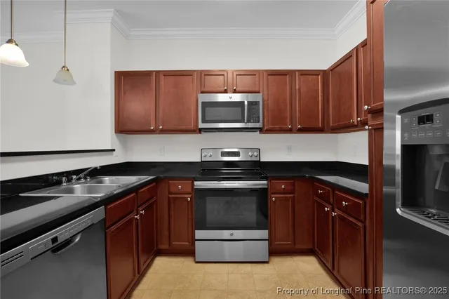 a kitchen with sink a microwave a stove and cabinets