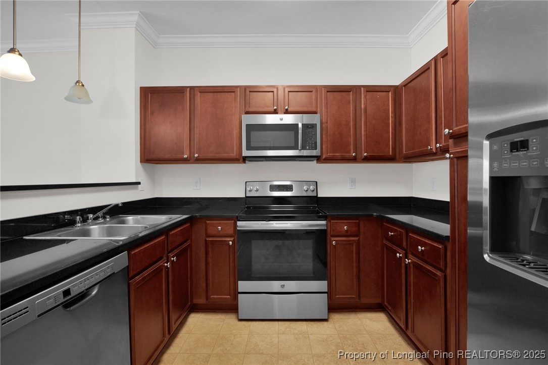 28 Hunter's Run Avenue Pembroke, NC 28372 - Photo 15 of 32 a kitchen with sink a microwave a stove and cabinets