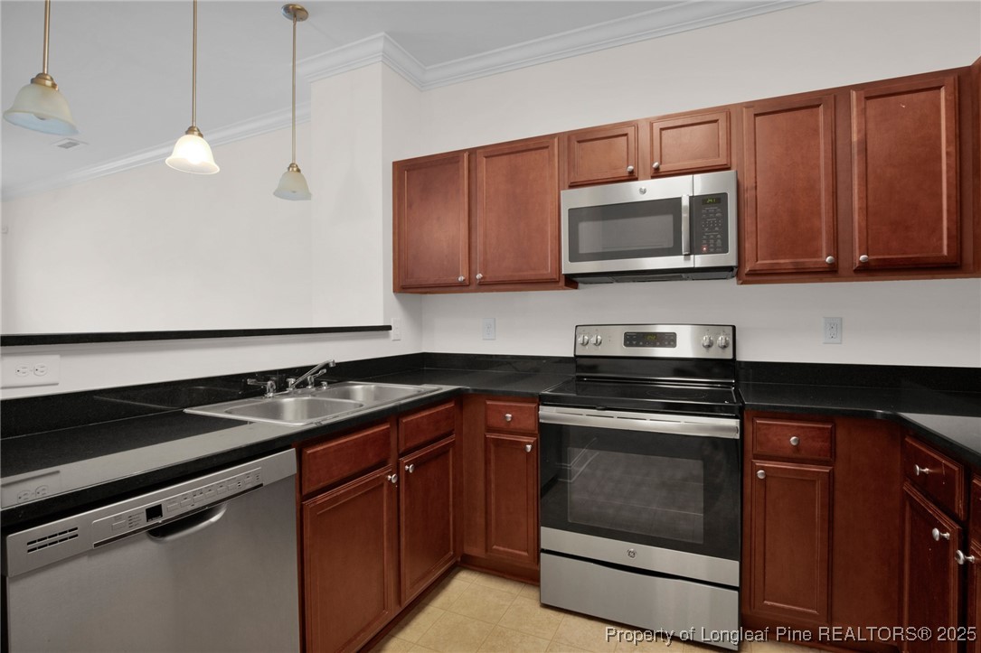 28 Hunter's Run Avenue Pembroke, NC 28372 - Photo 16 of 32 a kitchen with granite countertop a sink and a stove top oven