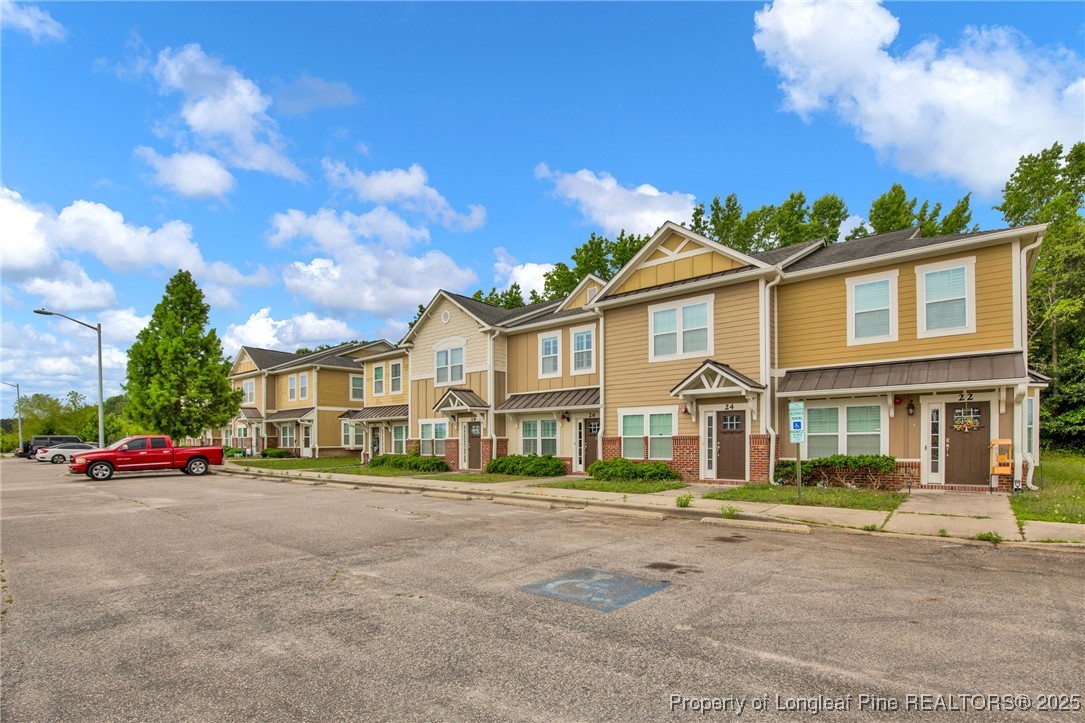 28 Hunter's Run Avenue Pembroke, NC 28372 - Photo 5 of 32 a front view of a house with a garden