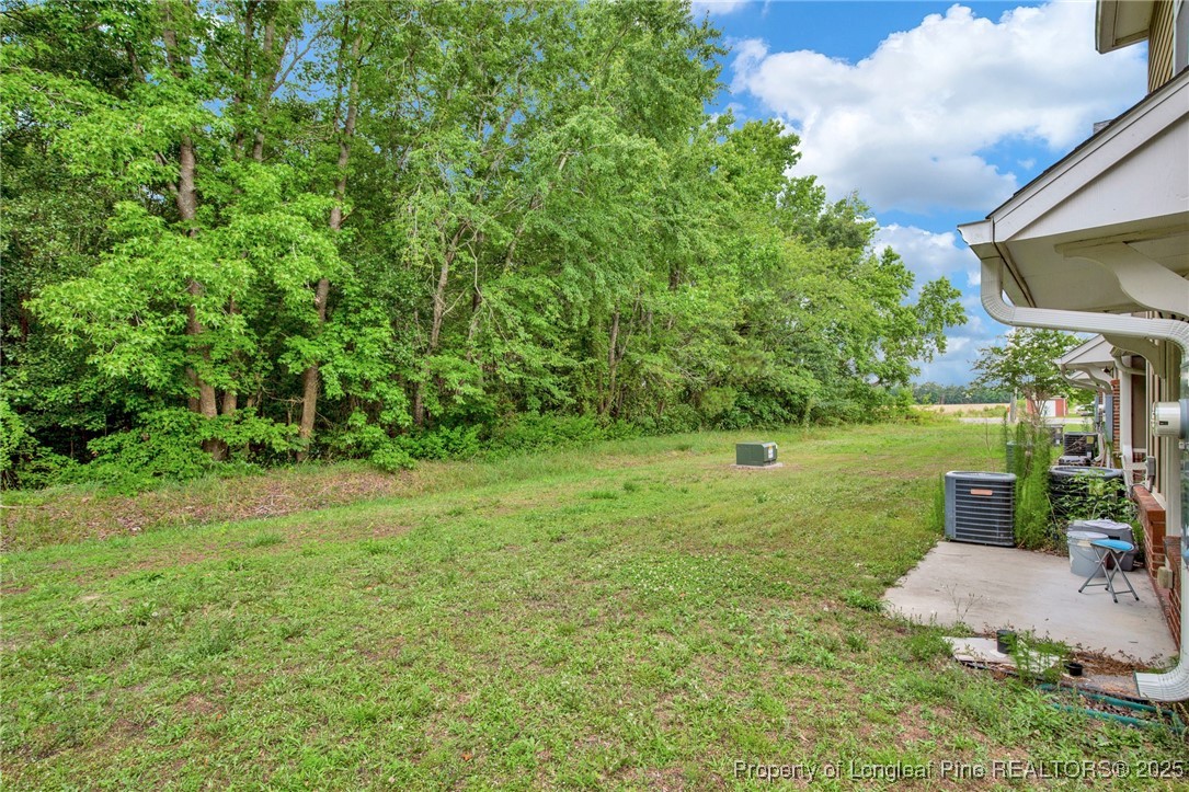 28 Hunter's Run Avenue Pembroke, NC 28372 - Photo 8 of 32 a view of a backyard with table and chairs and potted plants