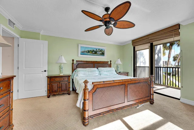 a bed room with a bed and a ceiling fan