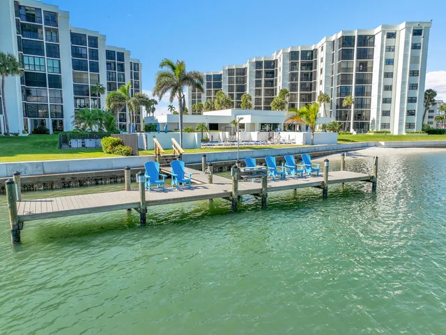 a dining room with furniture and a floor to ceiling window